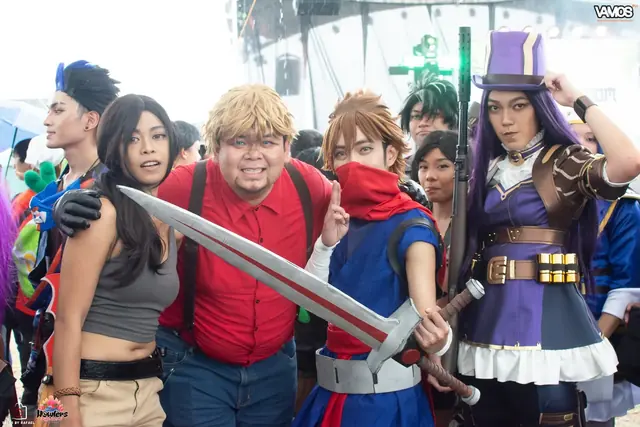 A group of cosplayers posing with a giant sword in the rain