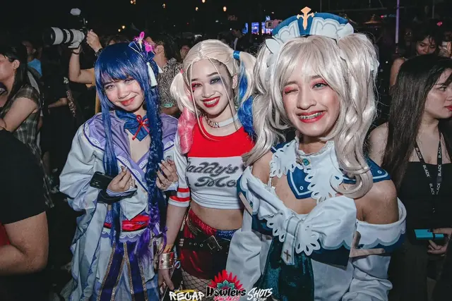 Three smiling cosplayers posing together at Howlers Manila